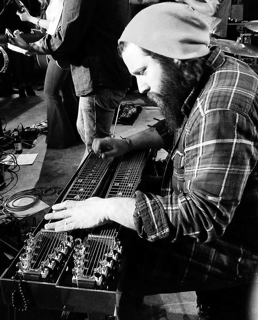 Tyler playing pedal steel guitar, black and white