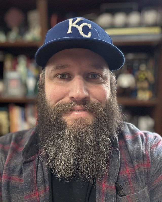 Tyler Giles, smiling, in a Kansas City Royals cap
